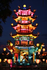 Fototapeta premium A vibrant Chinese lantern festival with colorful lanterns lighting up the night sky, illuminating ancient temples and city streets, Generative AI