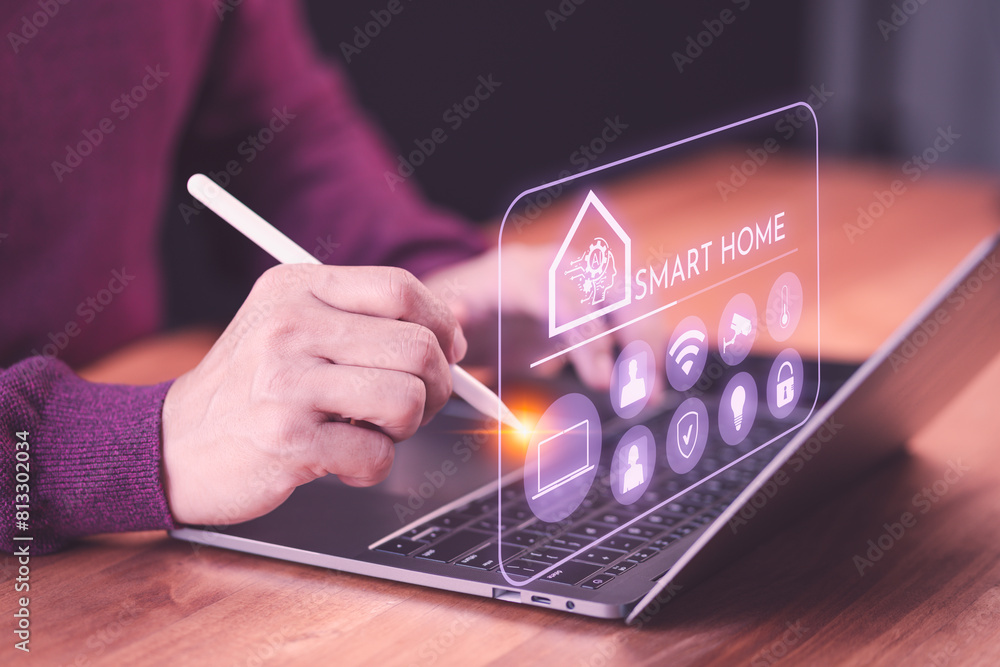 Aufkleber Adult man controls AI technology and smart home devices from his bedroom using a laptop, demonstrating the Internet of Things and smart home automation app concept.