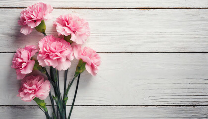 Pink carnations and white wooden background