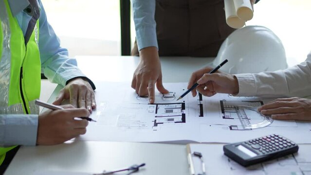 Architect or engineer are designing house, modifying plan, creating construction project and addition according to customer requirement.