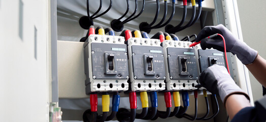 Professional electrician tests electrical installations. Measured with a multimeter to check...