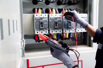 Professional electrician tests electrical installations. Measured with a multimeter to check accuracy.