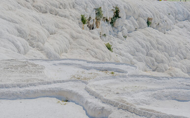Close-up of the textured white travertine terraces formed by calcium deposits, in Pamukkale, Turkiye