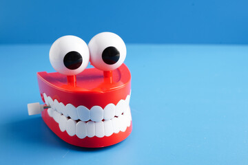 Funny red teeth with eye toy denture model for dental health care.