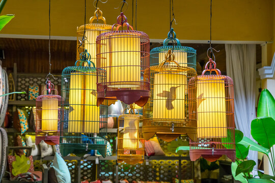 A collection of ornate bird cages hanging in a market stall at Hoi An in Vietnam