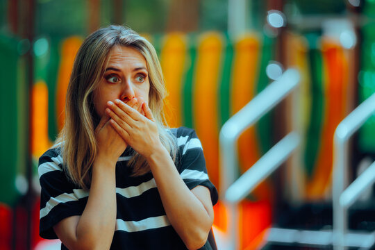 Woman Feeling Sick Covering her Mouth in a Park. Nauseated girl suffering from a gastrointestinal condition
