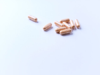 Lutein capsules. Dietary supplement on bright paper background. Soft focus. Close up. Copy space.	