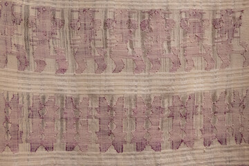 A purple and gray striped rug with a pattern of teeth