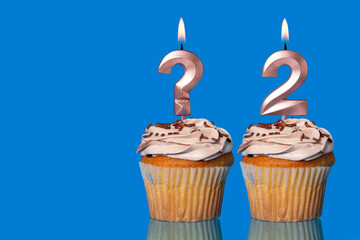 Birthday Cupcakes with Lit Question Mark Candle and Number 2
