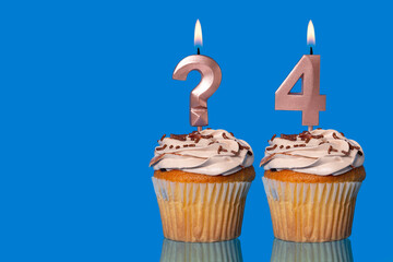 Birthday Cupcakes with Lit Question Mark Candle and Number 4