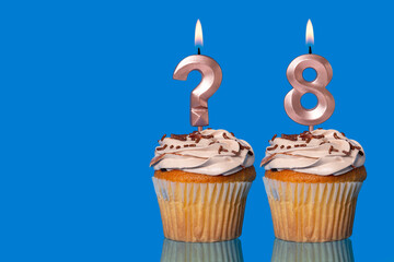 Birthday Cupcakes with Lit Question Mark Candle and Number 8