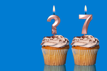 Birthday Cupcakes with Lit Question Mark Candle and Number 7