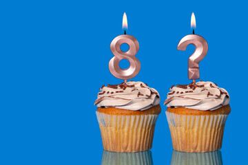 Birthday Cupcakes with Lit Number 8 and Question Mark candle