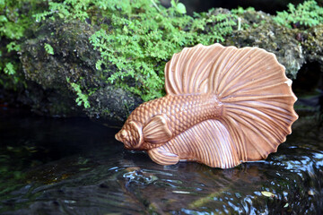 fighting fish sculpture in pond waterfall, backyard gardening for relaxing corner