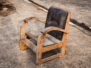 old wooden chairs drying in the sun on the front porch of the house