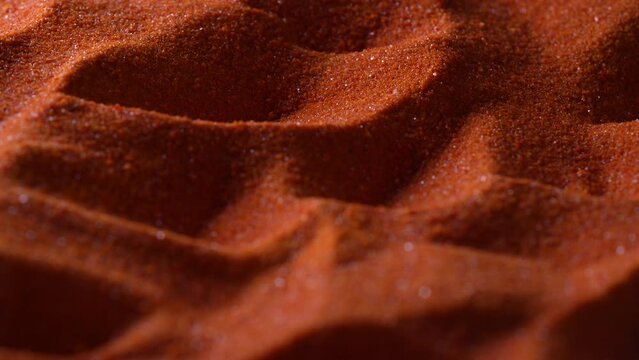 Small bright orange crystals of potassium dichromate, close up, abstract colorful background