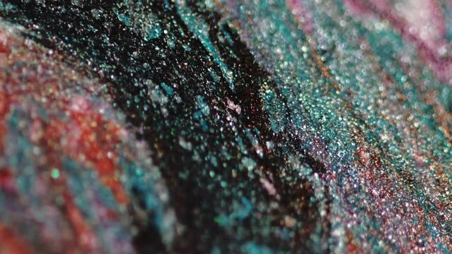 Glitter fluid spill. Paint blend. Blur blue orange pink black color shimmering wet particles texture ink mix flow motion abstract art background.