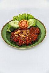 Empal Penyet consists of deep-seated beef cooked with kitchen spices such as bay leaves, galangal, lime leaves, tamarind, shallots, garlic, and many more.