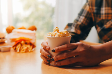 A woman holding a bowl of popcorn