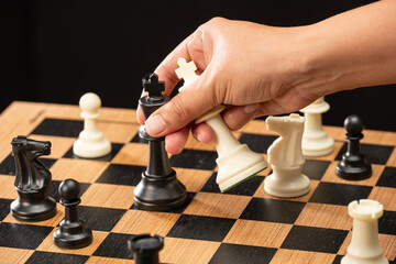 The hands of man on the competition and the strategic planning guidelines on the checkmate board....