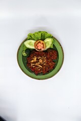 Empal Penyet consists of deep-seated beef cooked with kitchen spices such as bay leaves, galangal, lime leaves, tamarind, shallots, garlic, and many more.
