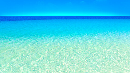 Nature of the beach and sea Summer with sunshine, sandy beaches, clear blue waters sparkling against the blue sky. On an island with good ecology and environment Background for summer vacation