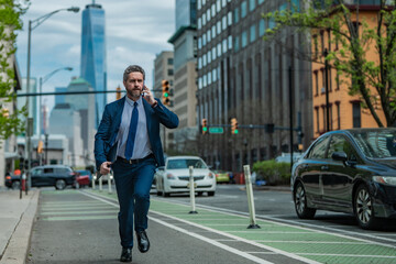 Man in suit with phone run in NY. Business talk. Businessman run down street talking on the phone. Man in suit late. Business call. Running business man. Fast business. Run and late businessman.
