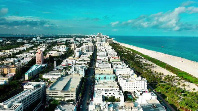 Flying over Ocean Dr in Miami South Beach on a cloudy day at dusk aerial view