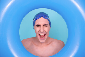 A funny guy who can't swim. A man is going to the pool. Blue background.