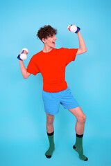Fitness and healthy lifestyle. Retro style. A young attractive man goes in for sports. Blue...