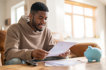 smiling man reading letter response to his job application loan mortgage 