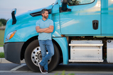 Men driver near lorry truck. Man owner truck driver in t-shirt near truck. Handsome middle aged man trucker trucking owner. Transportation industry vehicles. Handsome man driver front of truck.