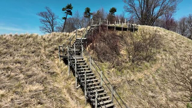 Drone descending against the dune and walkways.