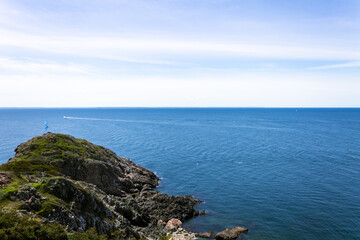 Lone Observer on Rugged Coastline