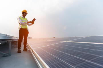 Engineer service check installation solar cell on the roof of factory on the morning. Silhouette...