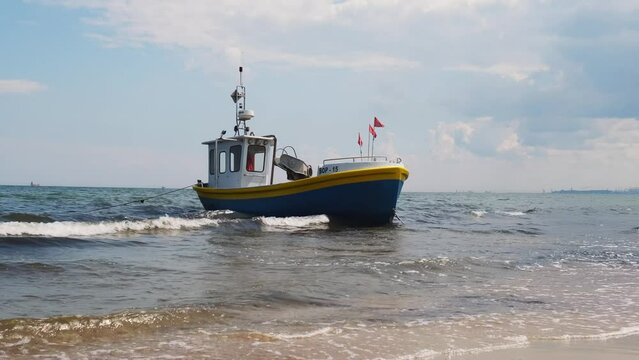 Fishing boat on the beach in Sopot, Poland. Magnificent calm Baltic Sea. Wallpaper defocused waves. Fishermans sea bay Vacation and holidays. travel attraction tourist destination 