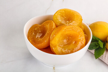 Few canned aprocots in the bowl