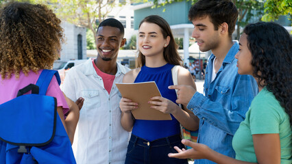 Group of laughing caucasian and latin american and black male and female students