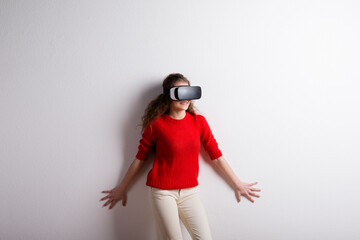 Young teenage girl with VR headset. Virutal reality, VR technology. Studio shot on white background...
