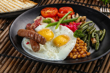 Traditional Engrlish breakfast with egg  and sausages