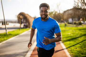 Young african-american man is jogging in the city.