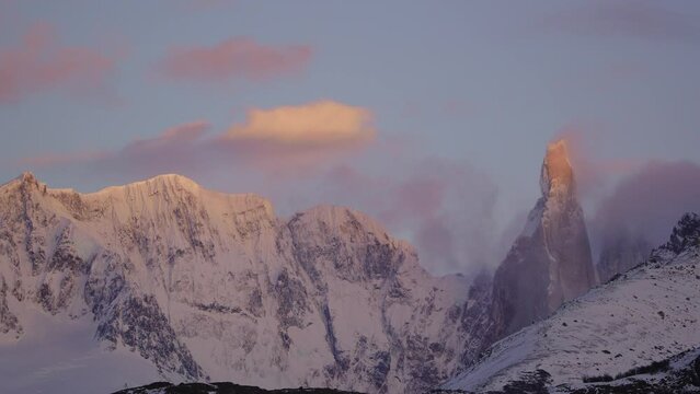 Torre Adela Summit in Patagonia Argentina glows with colorful orange-red hues. Sunrise timelapse