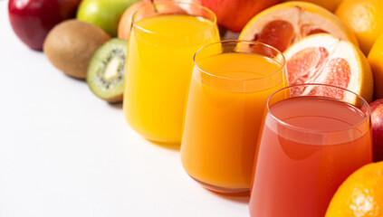 Different fruit juices in glasses on white background, copy space for text
