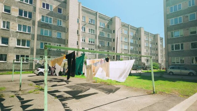 Wind breeze on clearn laundry sheets on Eastern European square in between apartment blocks