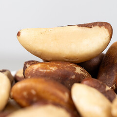 Macro brazil nuts on light grey background.