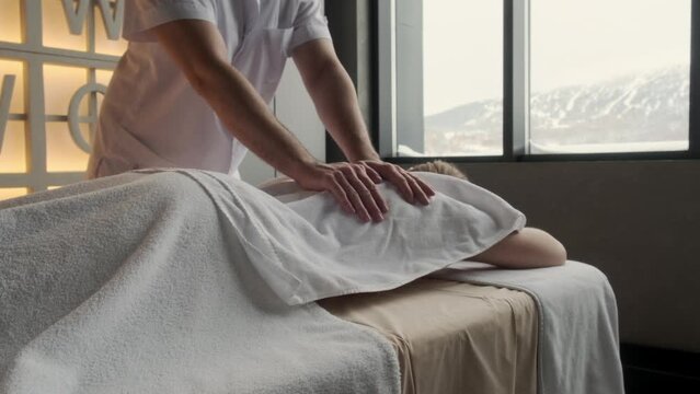 Relaxation woman back massage with masseur in cosmetology spa centre. Relaxing female customer get service aromatherapy massage with masseuse in spa salon.
