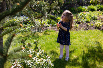 little girl in the garden, shadow and bright sun