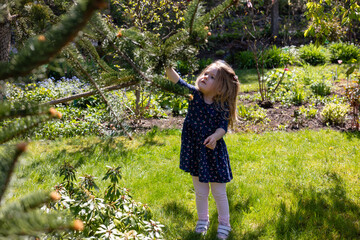 little girl in the garden, shadow and bright sun