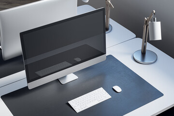 Close up and above view of designer office desk with mock up computer monitor on white desk, rug, lamp and other items. Mock up, 3D Rendering.