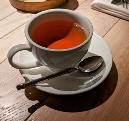 A cup of tea with a teaspoon